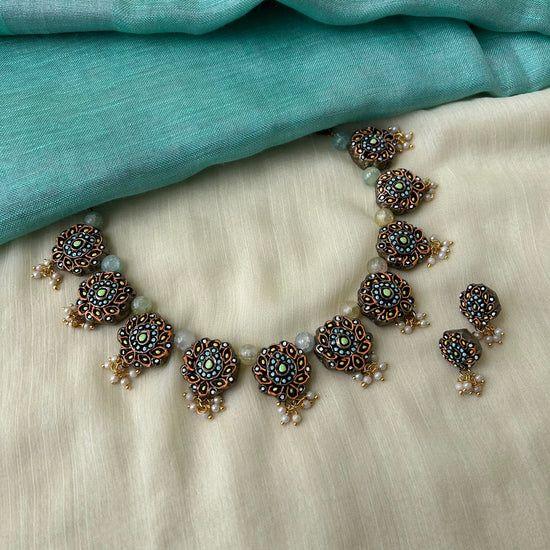 Floral clay necklace set in orange and teal with pearl accents