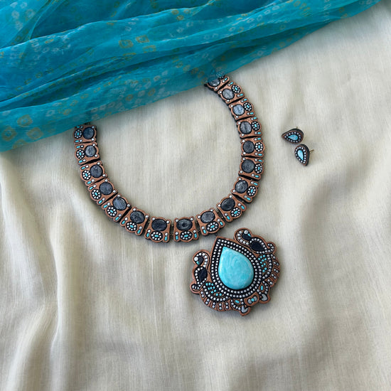 Handmade teal terracotta necklace with peacock motifs