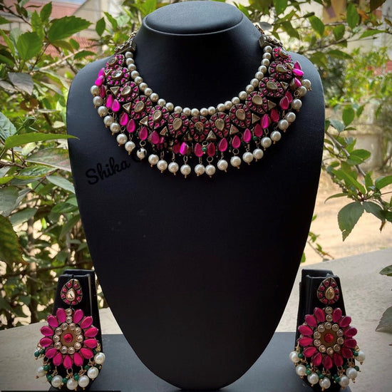 Oxidized silver finish clay choker set with magenta teardrops and white kundan stones