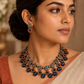 Handmade terracotta necklace set with leaf, floral, and geometric motifs in contrasting colours.
