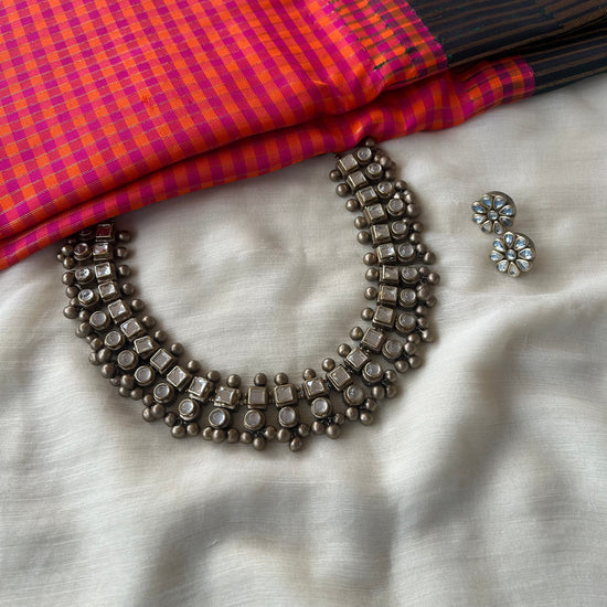 Handmade terracotta necklace set with white Kundan stone embellishments and antique-finish bead detailing.
