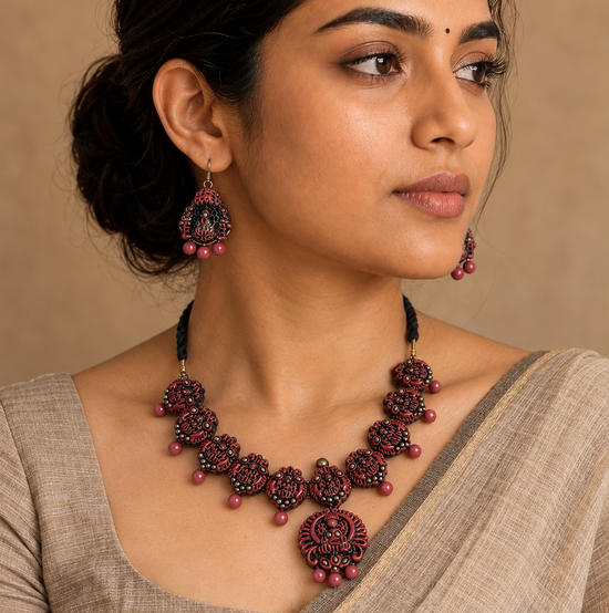 Handmade terracotta necklace set with intricate traditional motifs and matching terracotta bead danglers.
