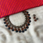 Handmade terracotta necklace set with leaf, floral, and geometric motifs in contrasting colours.