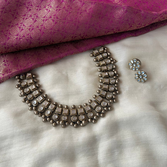 Handmade terracotta necklace set with white Kundan stone embellishments and antique-finish bead detailing.