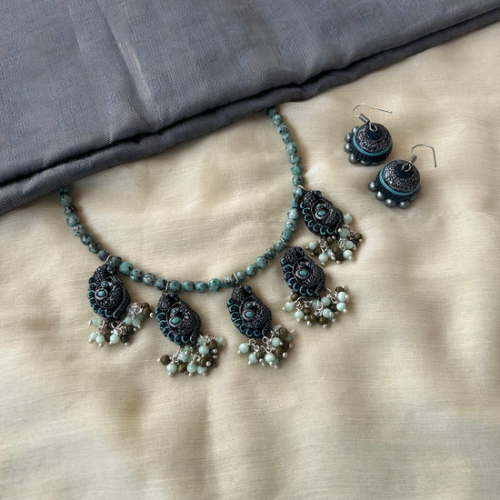 Handmade terracotta necklace set with semi-precious gemstone beads and antique-finish danglers.