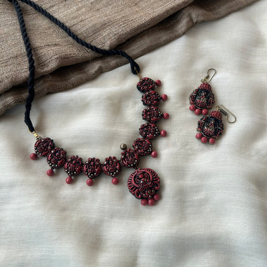 Handmade terracotta necklace set with intricate traditional motifs and matching terracotta bead danglers.