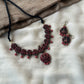 Handmade terracotta necklace set with intricate traditional motifs and matching terracotta bead danglers.