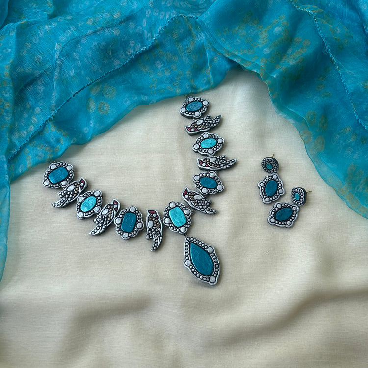 Handmade teal terracotta necklace with bird motif and stud earrings