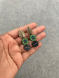 Three-piece terracotta danglers with leaf stud, green floral circle, and navy semi-circle pendant