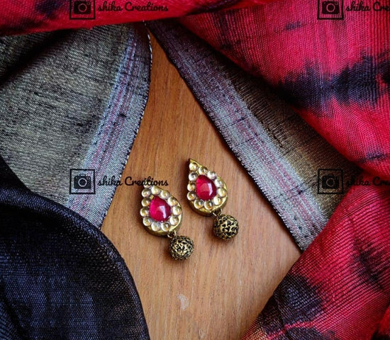 Handmade terracotta clay red kemp teardrop stud earrings with brown antique clay bead.