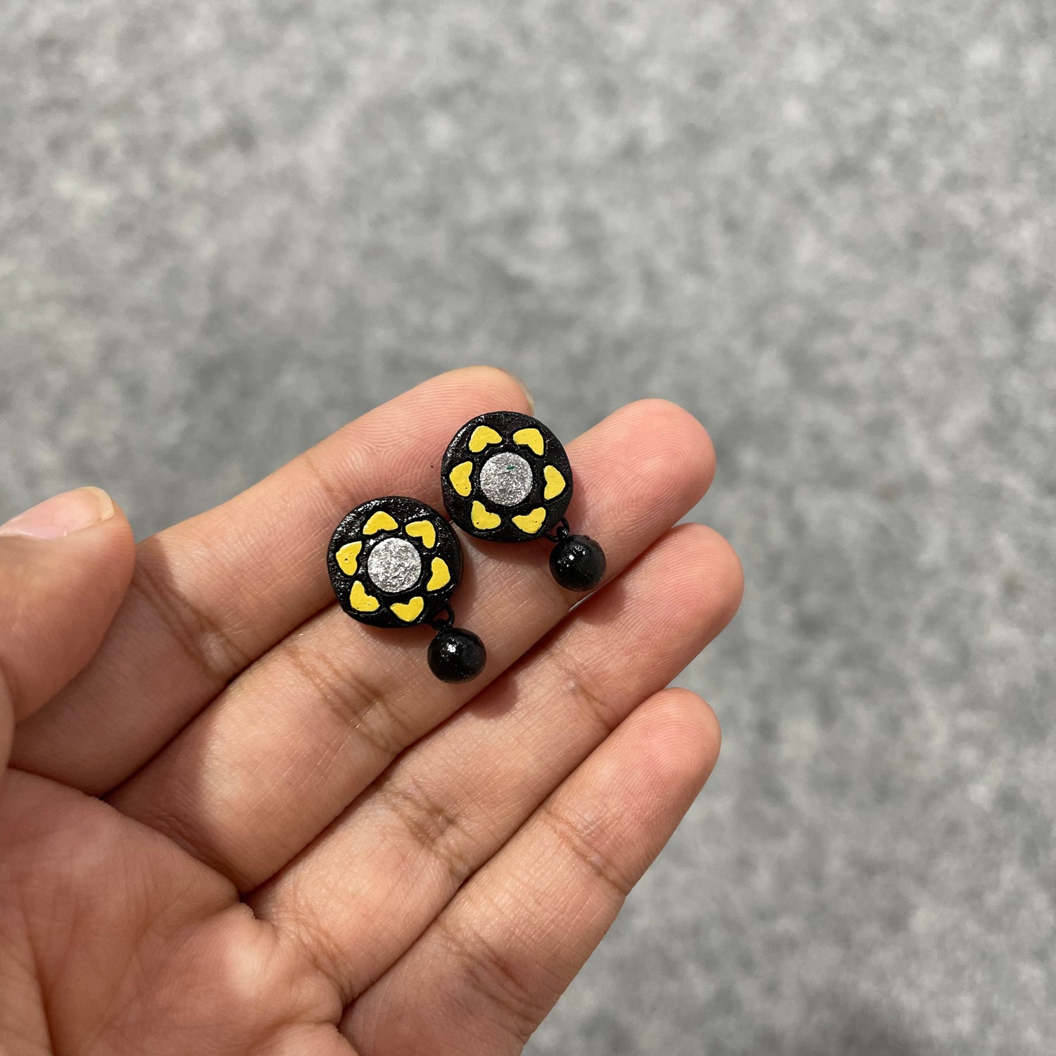 Handmade black and yellow flower terracotta clay stud earrings with a bead drop.